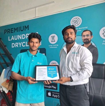 A trainee receiving a Laundry Legend Academy certificate