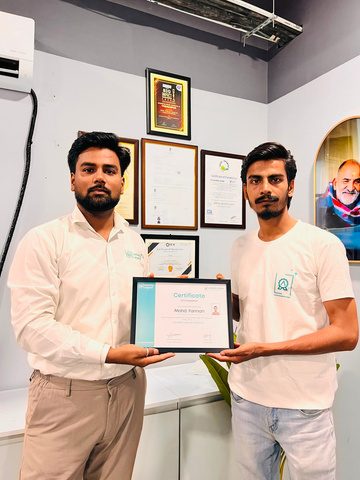 A trainee receiving a Laundry Legend Academy certificate